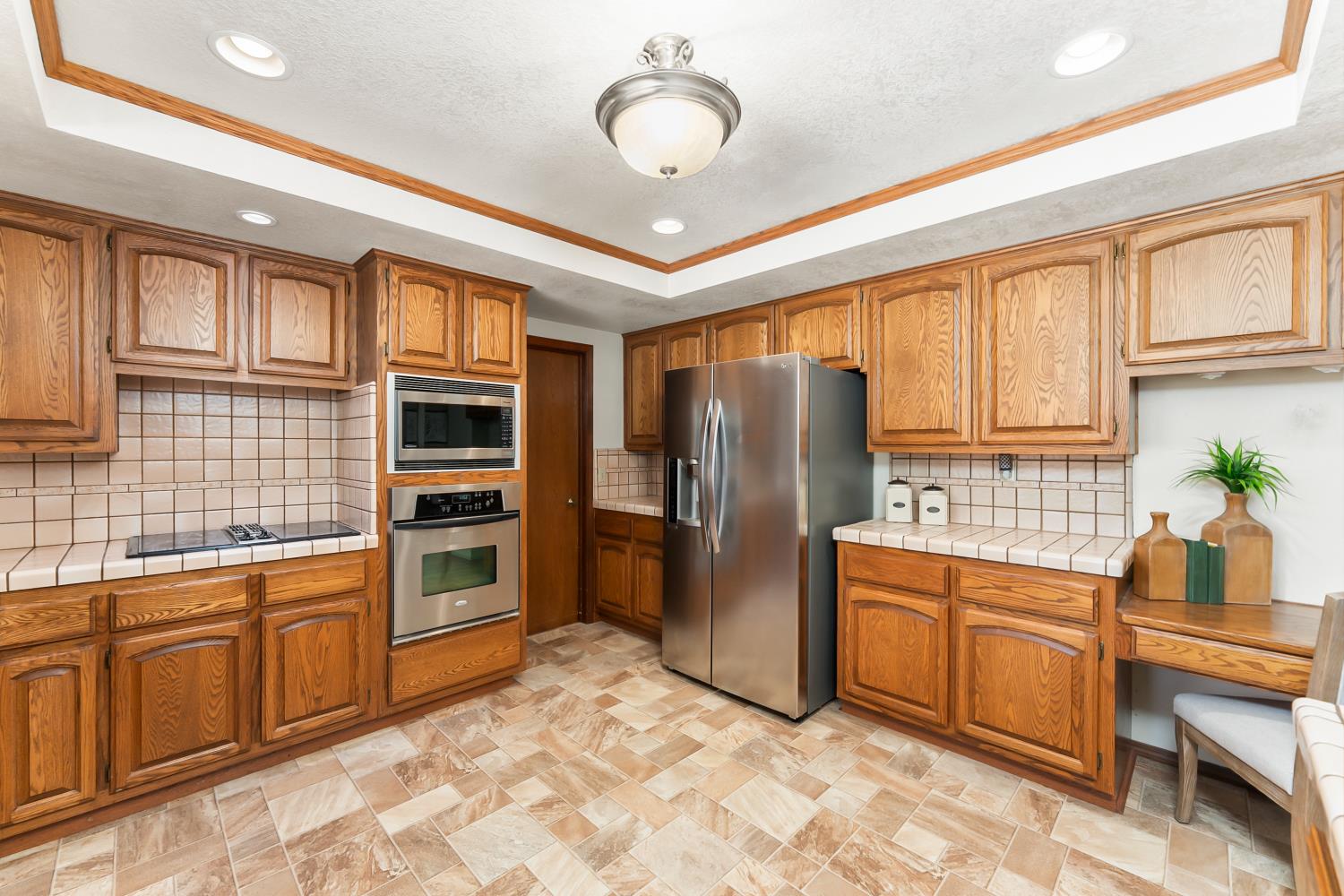3708 Millbrae Road Cameron Park, CA 95682 - Photo 15 of 48 a kitchen with stainless steel appliances granite countertop a refrigerator and a stove top oven