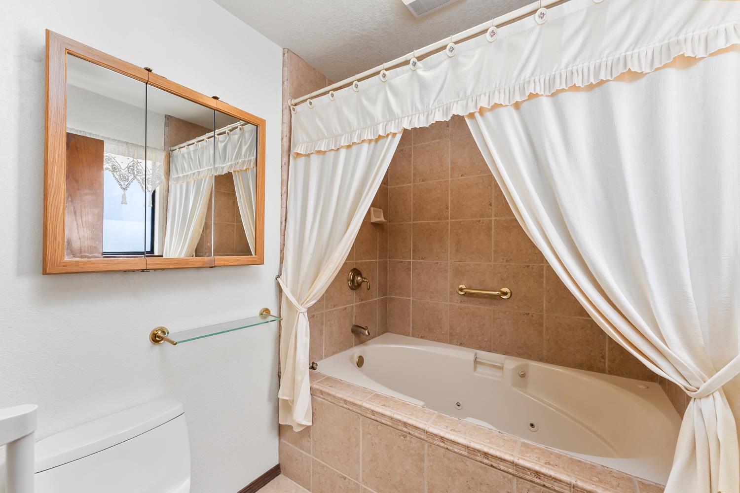 3708 Millbrae Road Cameron Park, CA 95682 - Photo 19 of 48 a bathroom with a bathtub and a shower
