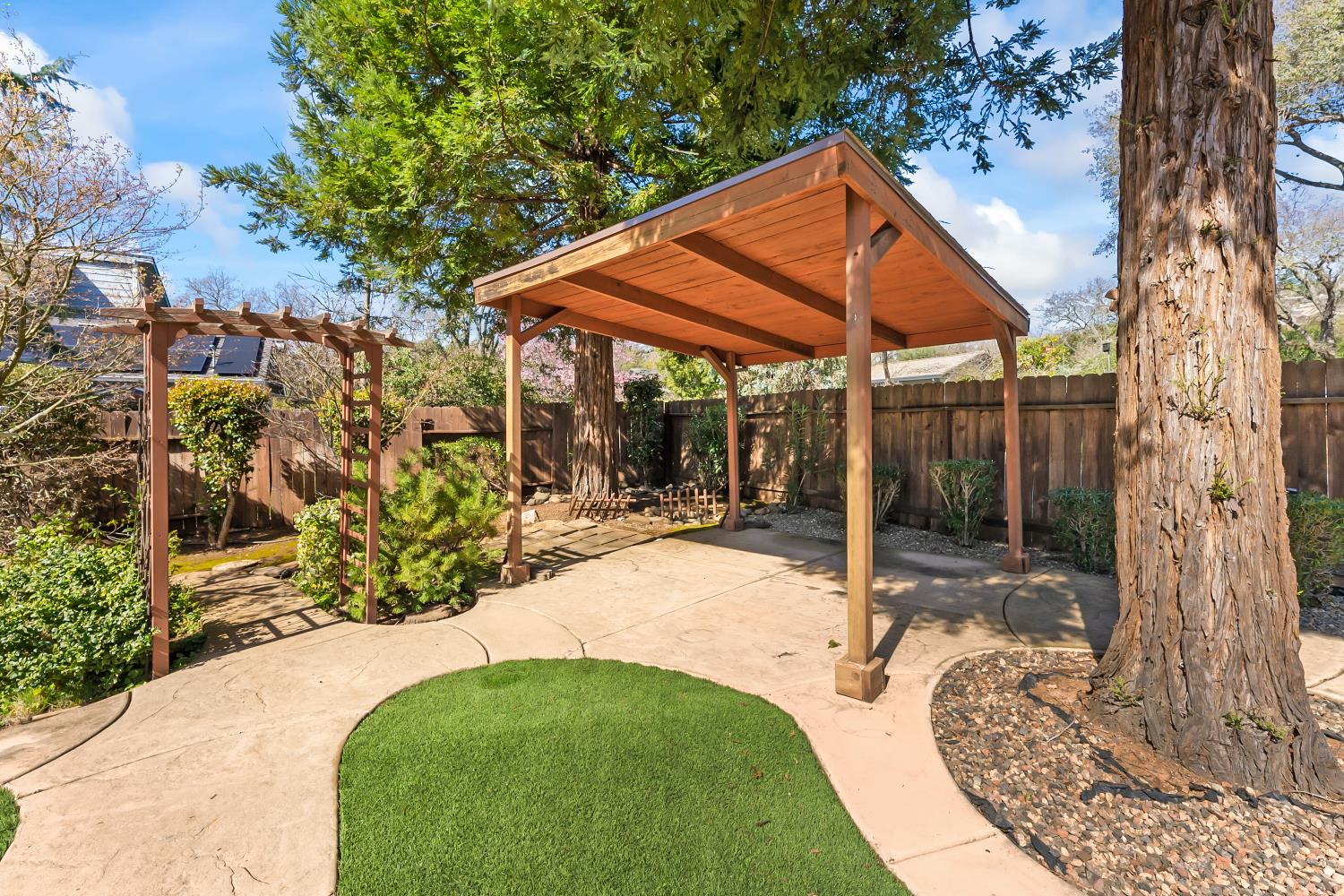 3708 Millbrae Road Cameron Park, CA 95682 - Photo 39 of 48 a view of a patio with table and chairs under an umbrella