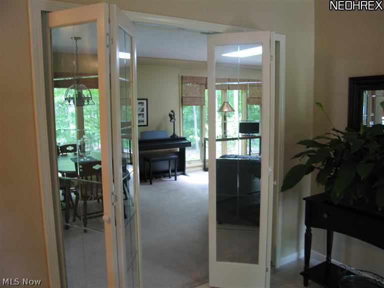 Glass French doors lead from the foyer into the more formal living room/dining area. Green, private views are out every window. Only nature to enjoy.
