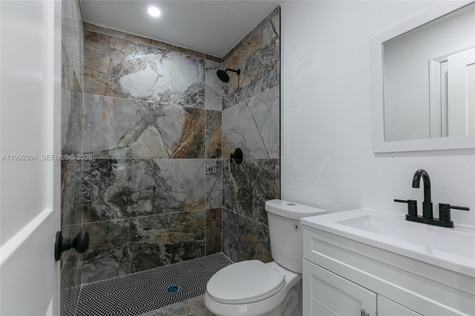 6125 Southwest 40th Court Miramar, FL 33023 - Photo 12 of 43 a bathroom with a sink a toilet and shower