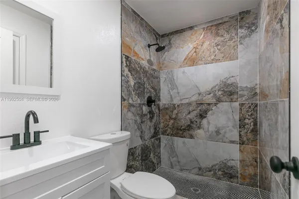 a bathroom with a sink toilet and shower