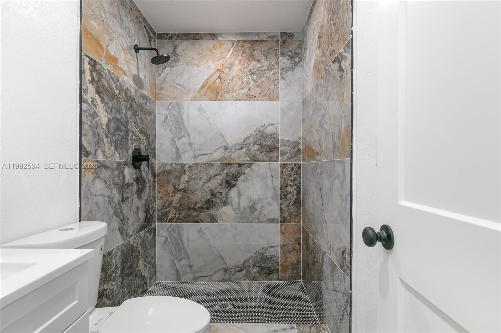 6125 Southwest 40th Court Miramar, FL 33023 - Photo 20 of 43 a bathroom with a toilet and a shower