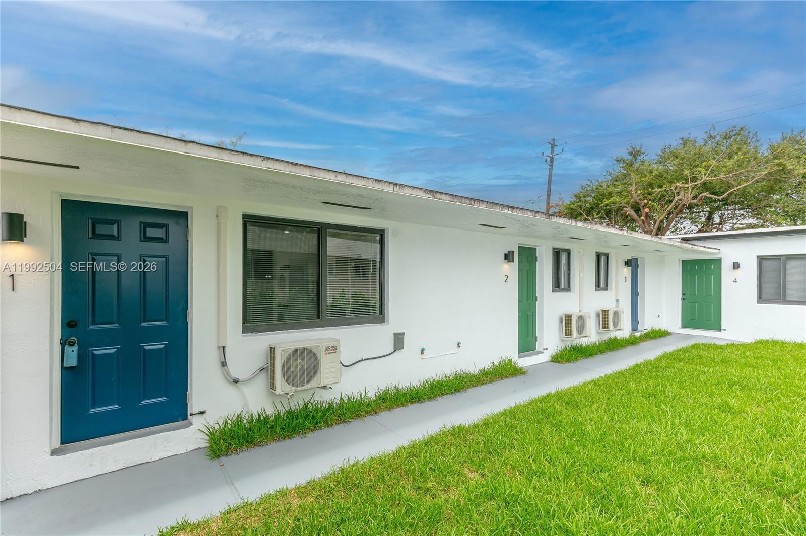 6125 Southwest 40th Court Miramar, FL 33023 - Photo 2 of 43 a front view of a house with a yard