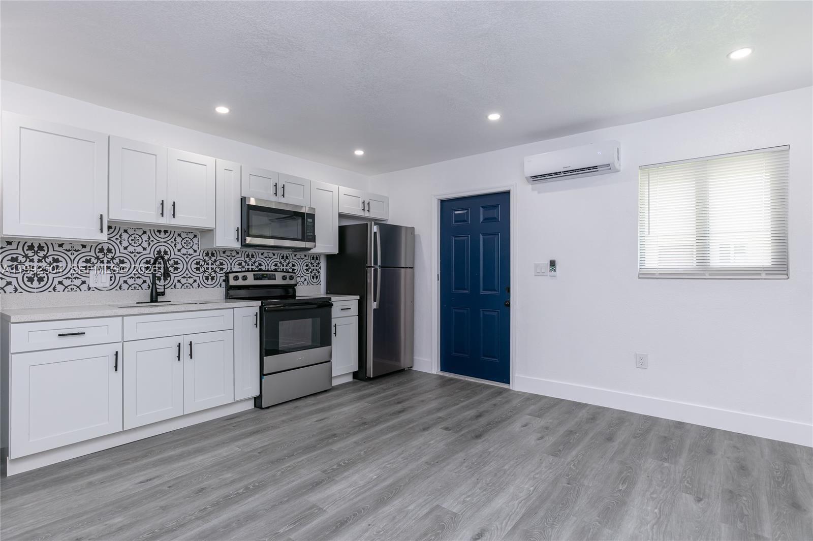 6125 Southwest 40th Court Miramar, FL 33023 - Photo 24 of 43 a large kitchen with stainless steel appliances granite countertop a stove a sink and a refrigerator
