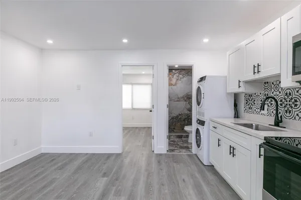 a kitchen with stainless steel appliances granite countertop a stove and a refrigerator