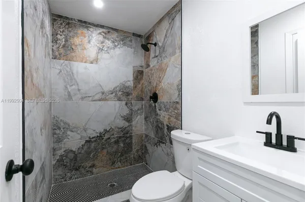 a bathroom with a toilet sink and shower