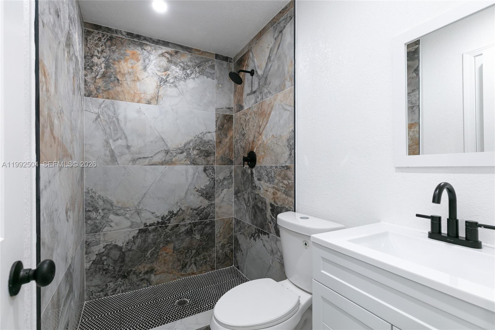 6125 Southwest 40th Court Miramar, FL 33023 - Photo 26 of 43 a bathroom with a toilet sink and shower