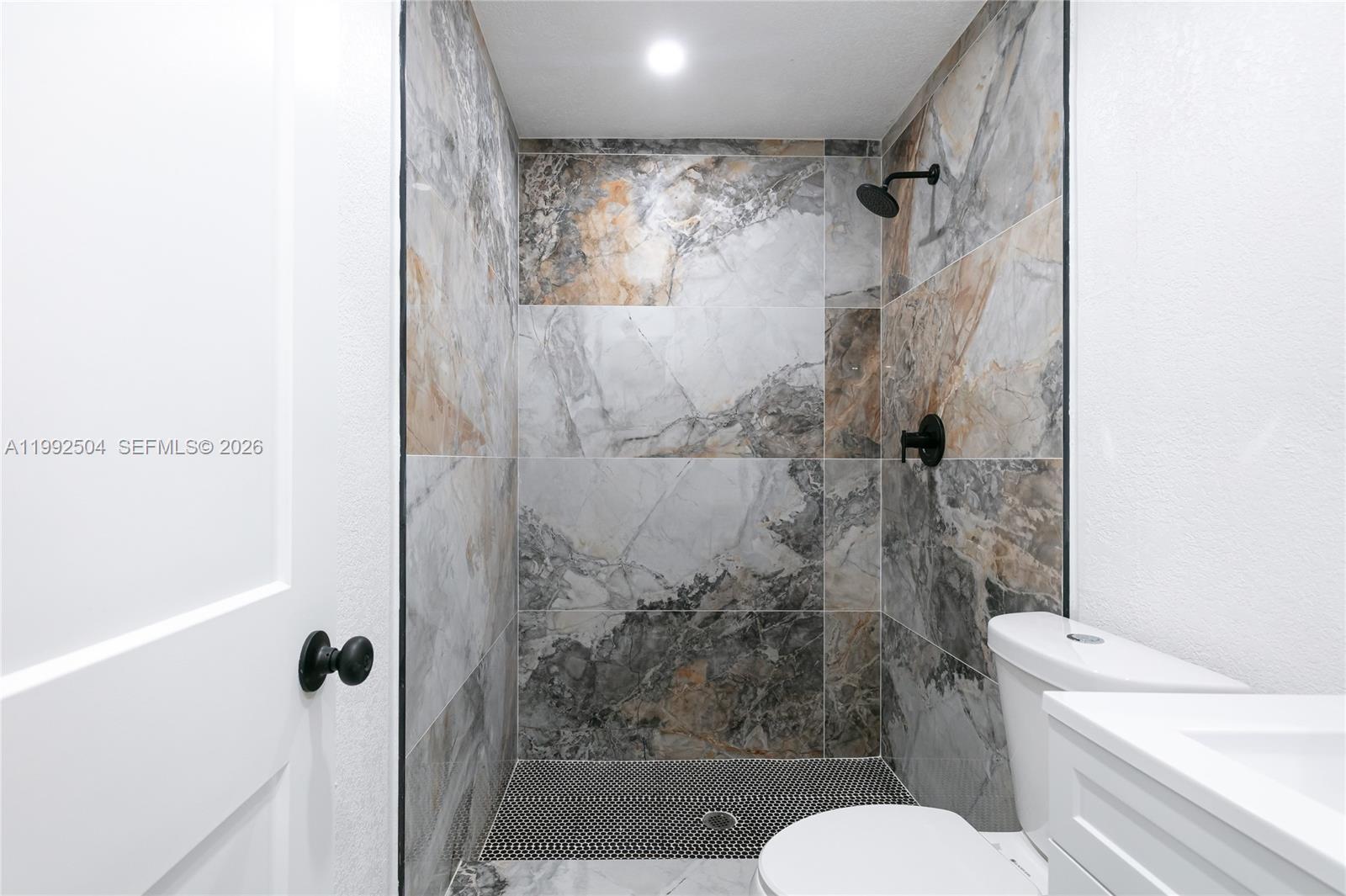 6125 Southwest 40th Court Miramar, FL 33023 - Photo 27 of 43 a bathroom with a shower and toilet