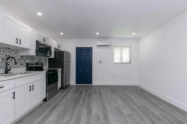 a kitchen with stainless steel appliances a refrigerator sink and cabinets