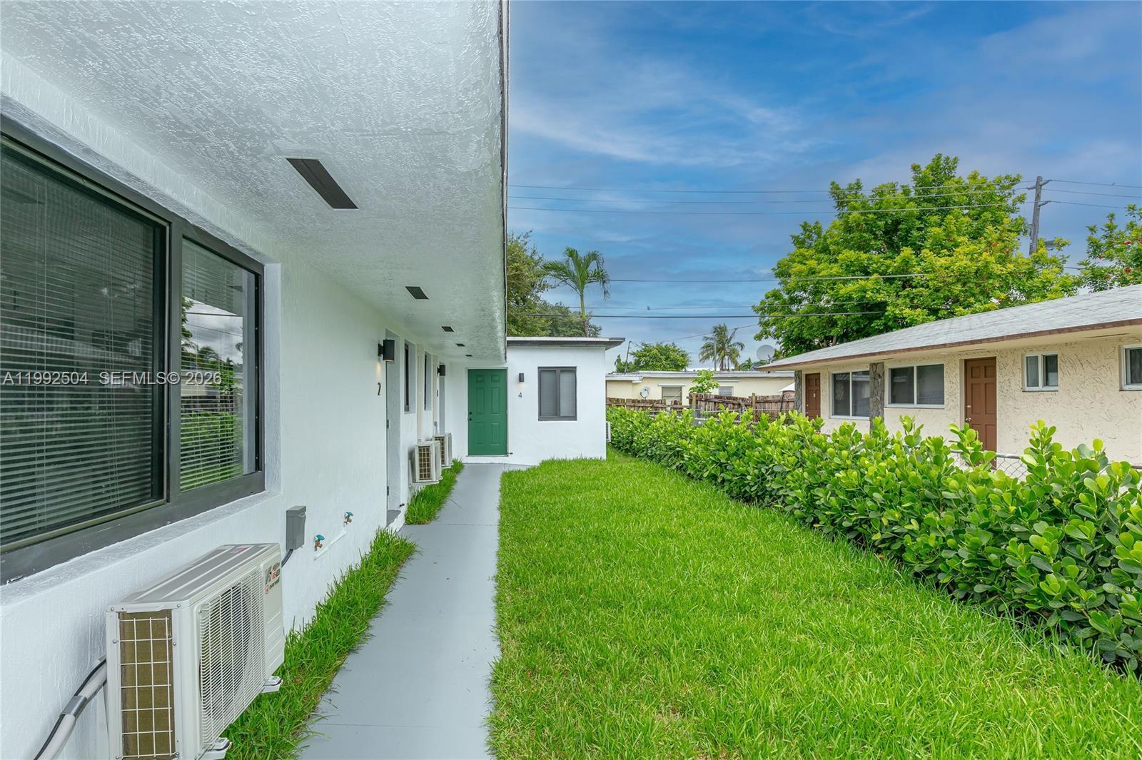 6125 Southwest 40th Court Miramar, FL 33023 - Photo 3 of 43 a front view of a house with a yard and trees