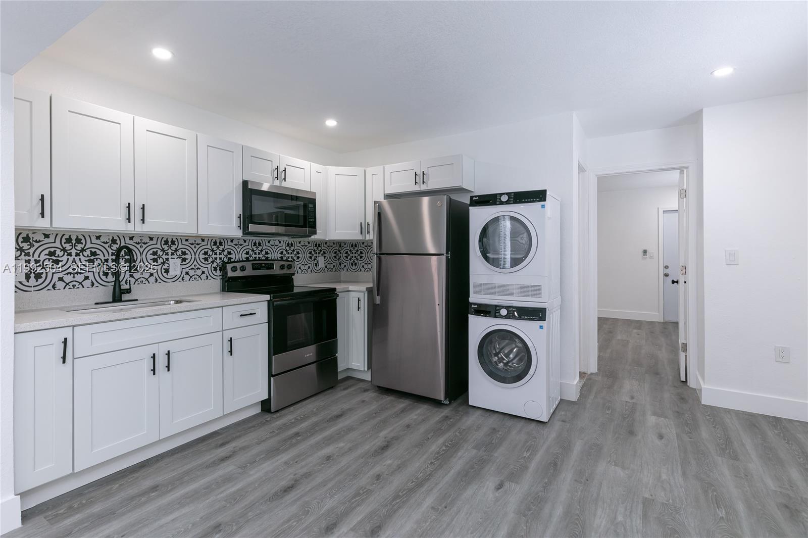 6125 Southwest 40th Court Miramar, FL 33023 - Photo 32 of 43 a kitchen with stainless steel appliances granite countertop a stove a refrigerator and a microwave