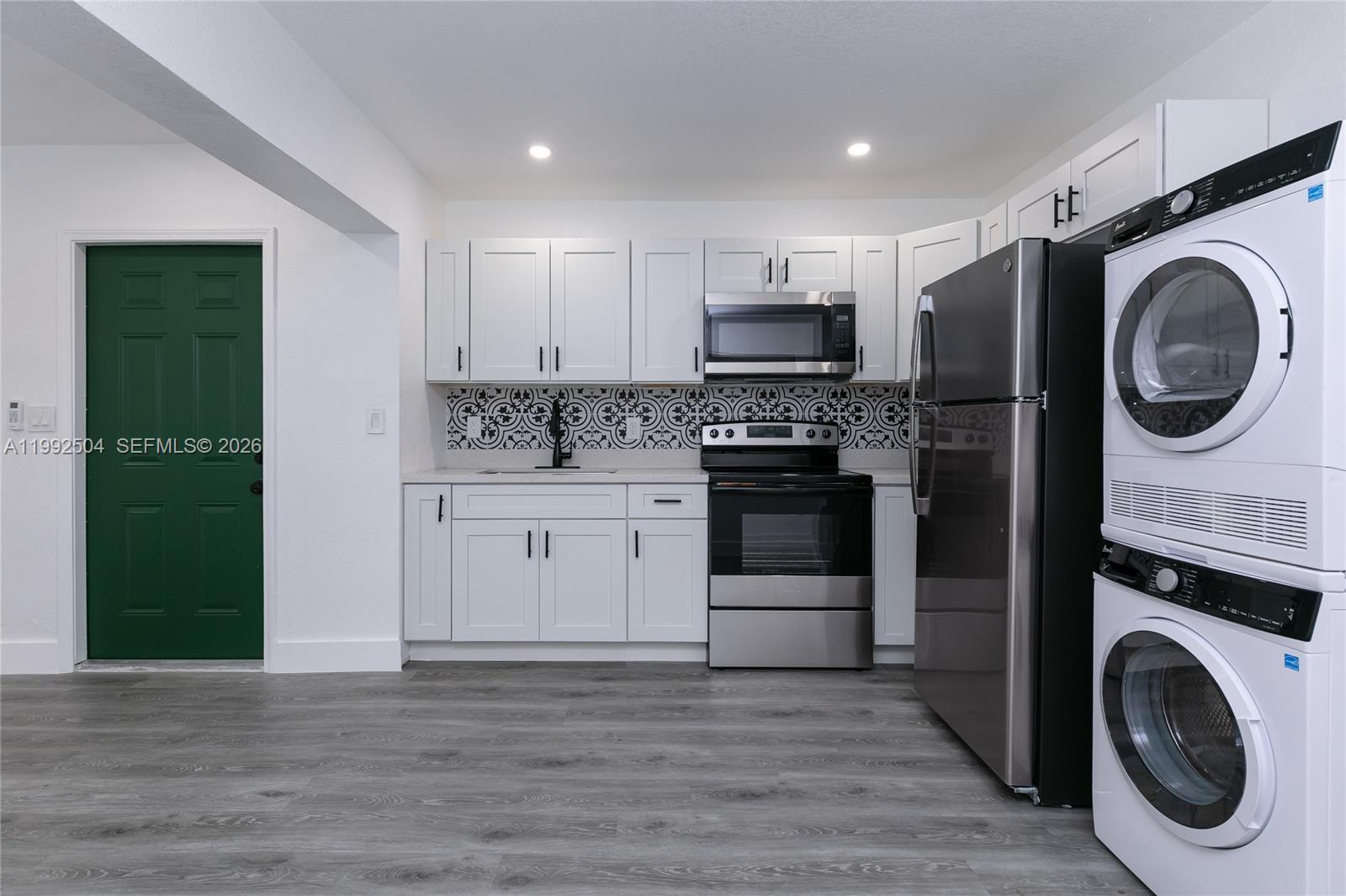 6125 Southwest 40th Court Miramar, FL 33023 - Photo 33 of 43 a kitchen with stainless steel appliances granite countertop a stove a washer and a sink