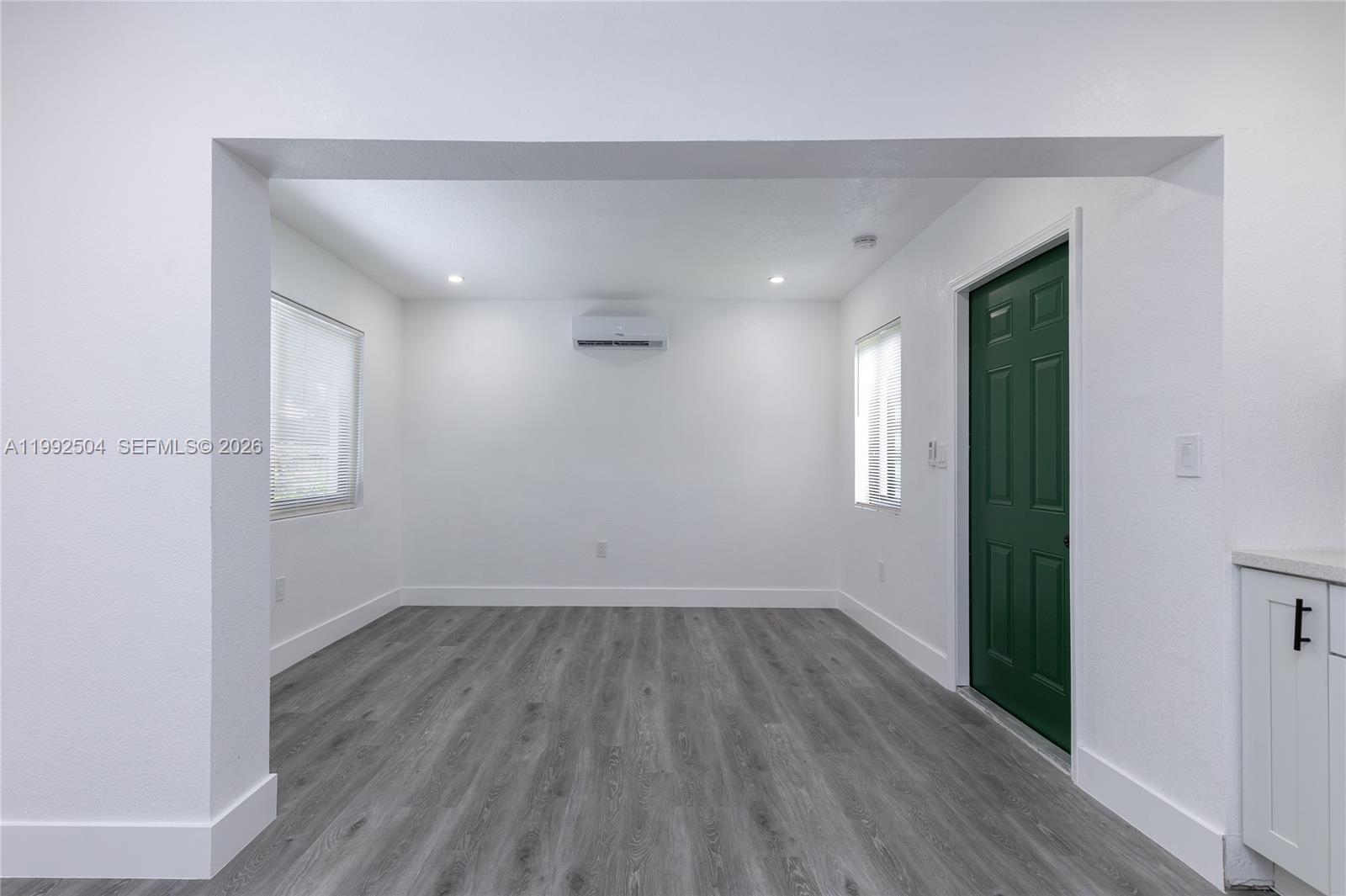 6125 Southwest 40th Court Miramar, FL 33023 - Photo 35 of 43 an empty room with wooden floor and windows