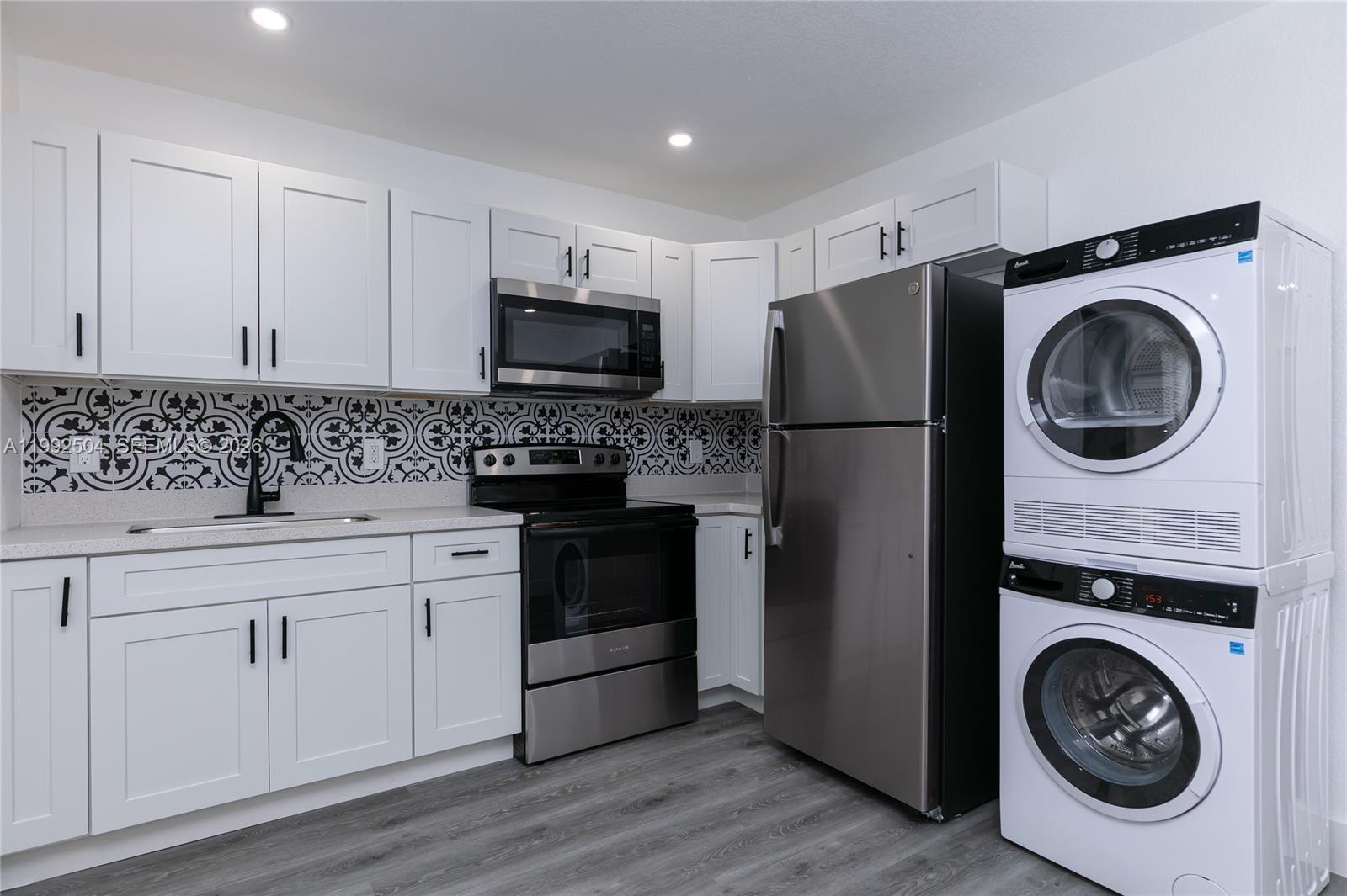 6125 Southwest 40th Court Miramar, FL 33023 - Photo 38 of 43 a kitchen with a refrigerator sink and cabinets