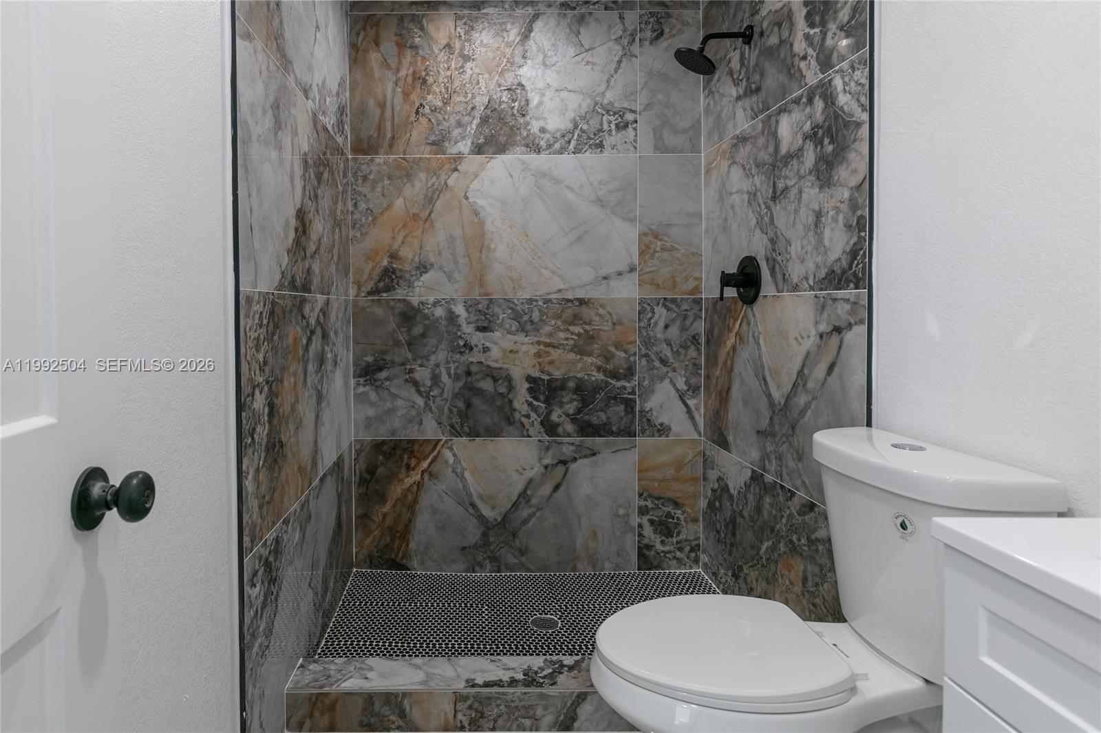 6125 Southwest 40th Court Miramar, FL 33023 - Photo 40 of 43 a white toilet sitting next to a bath tub and a shower
