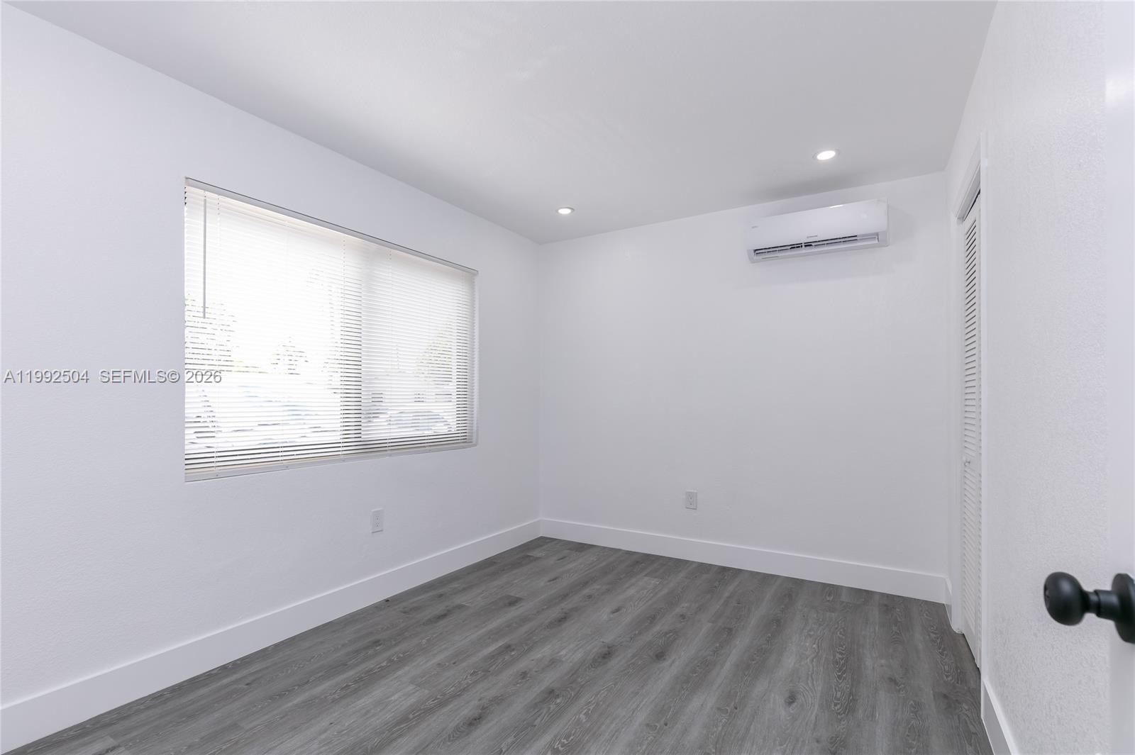 6125 Southwest 40th Court Miramar, FL 33023 - Photo 10 of 43 an empty room with wooden floor and windows