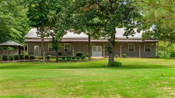 a front view of a house with a garden and porch
