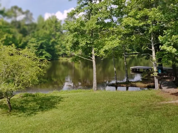 a swimming pool with outdoor seating and yard
