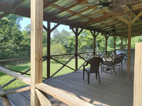 a view of a porch with furniture and wooden floor