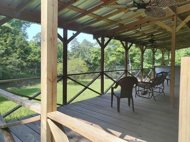 a view of a porch with furniture and wooden floor