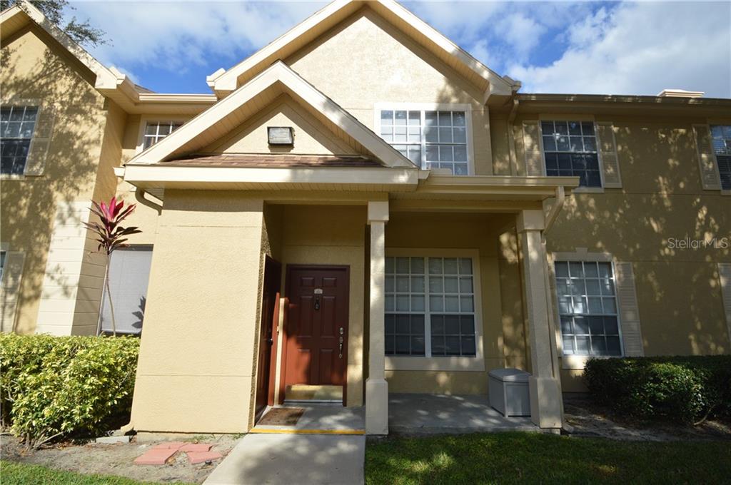 830 Grand Regency Pointe, Unit 102 Altamonte Springs, FL 32714 - Photo 1 of 1 a front view of a house with a yard