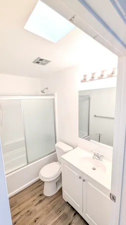 a bathroom with a sink a toilet and a shower
