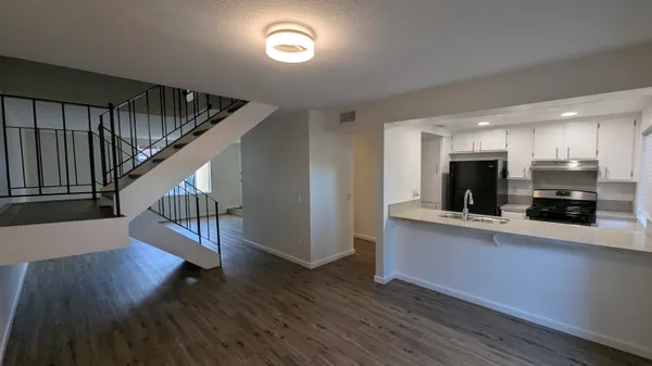 a view of kitchen with cabinets and wooden floor