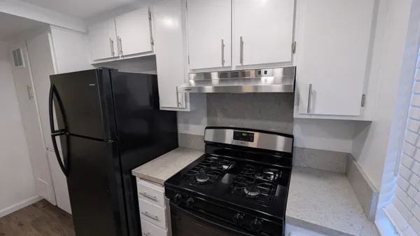 a kitchen with stainless steel appliances a refrigerator and a stove