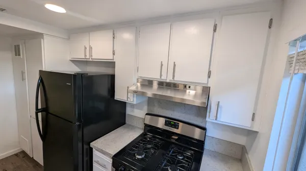 a kitchen with stainless steel appliances a refrigerator and cabinets