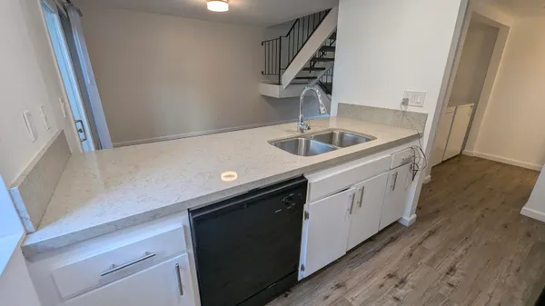 a kitchen with a sink cabinets and stainless steel appliances