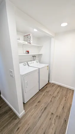 a utility room with cabinets washer and dryer