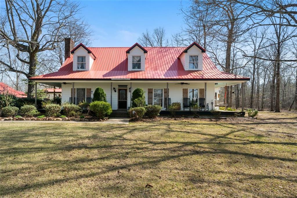 680 Milligan Creek Road Roopville, GA 30170 - Photo 1 of 1 a front view of a house with a garden