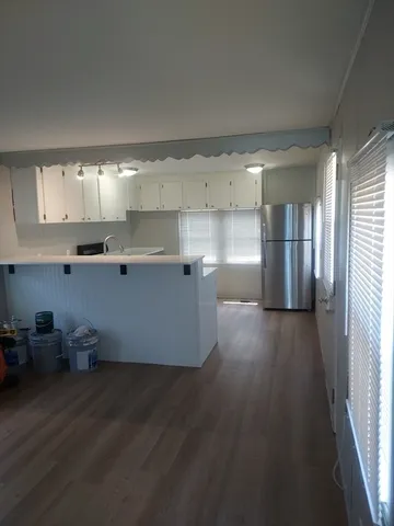 a view of a kitchen with wooden floor