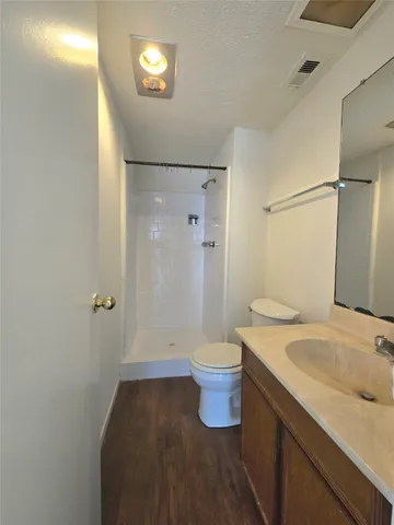 a view of a room with wooden floor