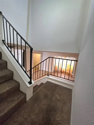 an empty room with a window and a ceiling fan