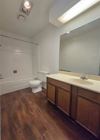 a spacious bathroom with a double vanity sink toilet and shower