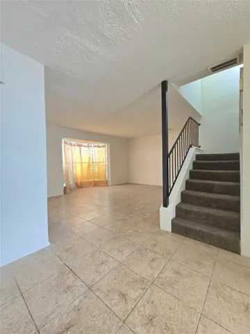 a kitchen with a stove a sink and a refrigerator