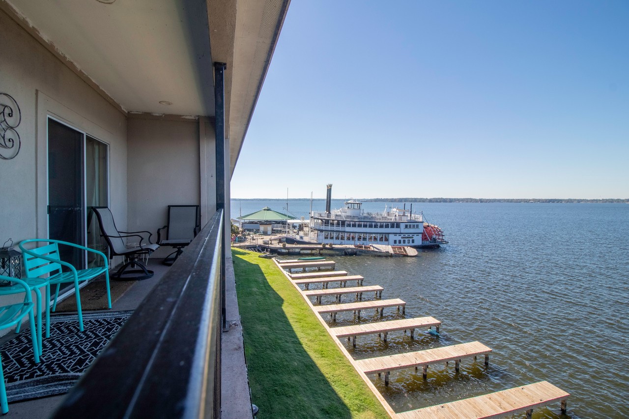 7039 Kingston Cove Lane, Unit 307 Willis, TX 77318 - Photo 1 of 11 a view of balcony and wooden floor