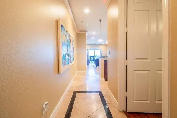 a view of a hallway with wooden floor