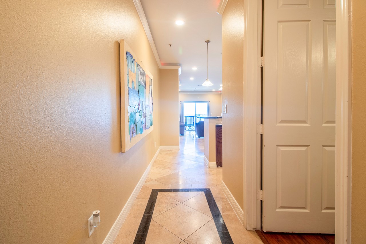 7039 Kingston Cove Lane, Unit 307 Willis, TX 77318 - Photo 2 of 11 a view of a hallway with wooden floor