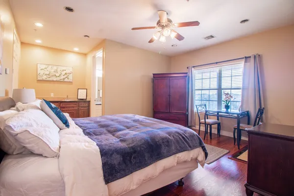 a bedroom with a large bed and a chandelier