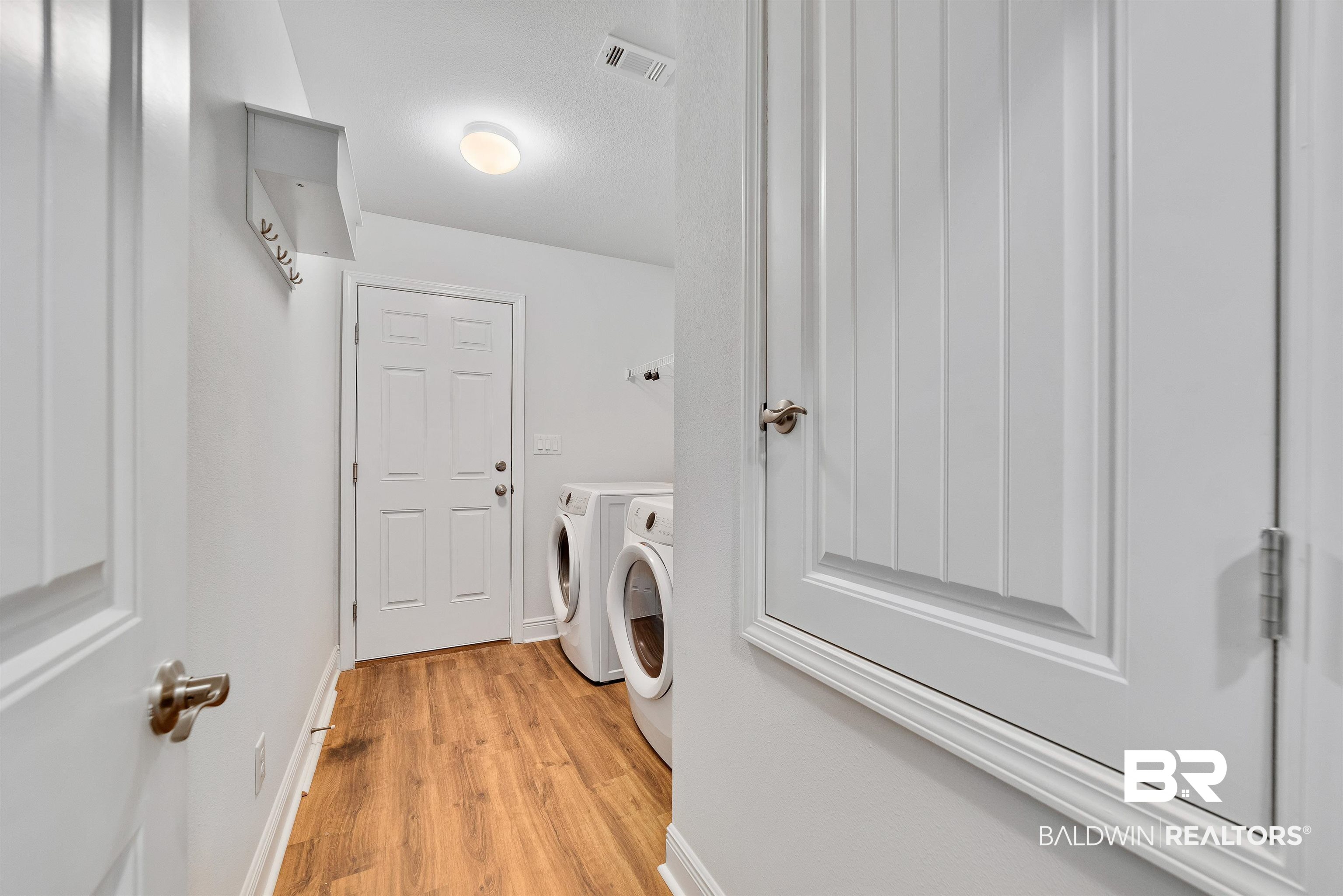 13155 Wishbone Court Foley, AL 36535 - Photo 30 of 39 Laundry room with washer and dryer and light hardwood / wood-style floors