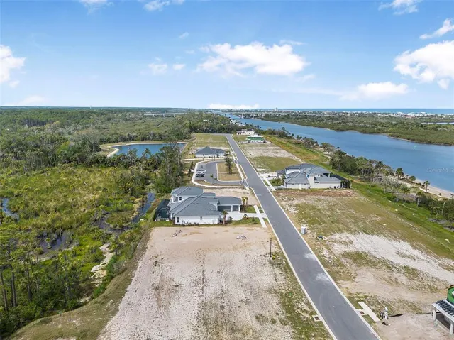 an aerial view of a house with a lake view