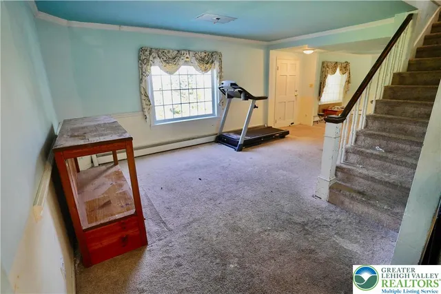 a view of an empty room and stairs