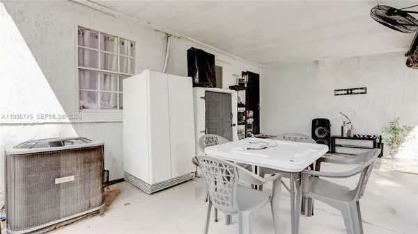 a view of a dining room with furniture and a chandelier