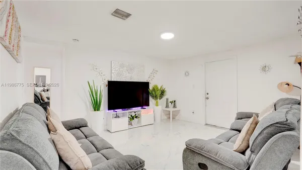 a living room with furniture and a flat screen tv