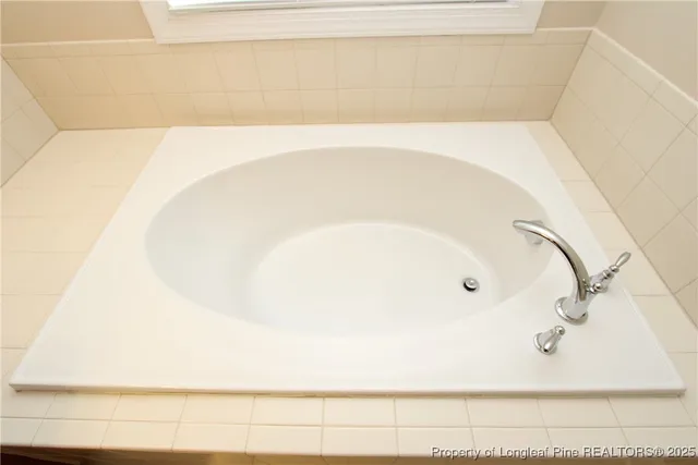 a white toilet sitting next to a white wall