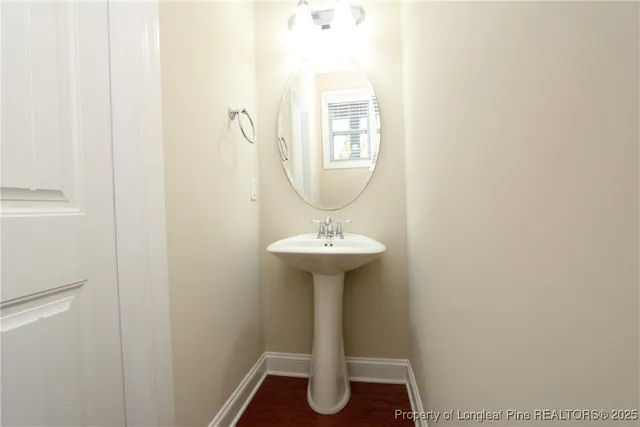 a bathroom with a sink a mirror and a window