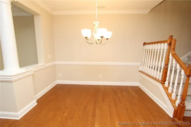 a view of a room with wooden floor and windows